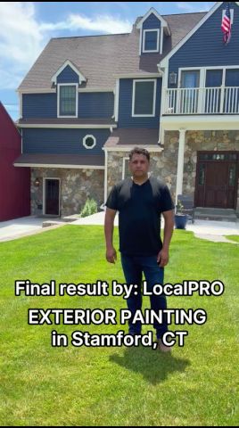 Exterior painting project film showing a completed blue-sided home in Stamford, Connecticut